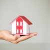Businessman Holding Model House Businessman Holding Model House In Palm Of Hand